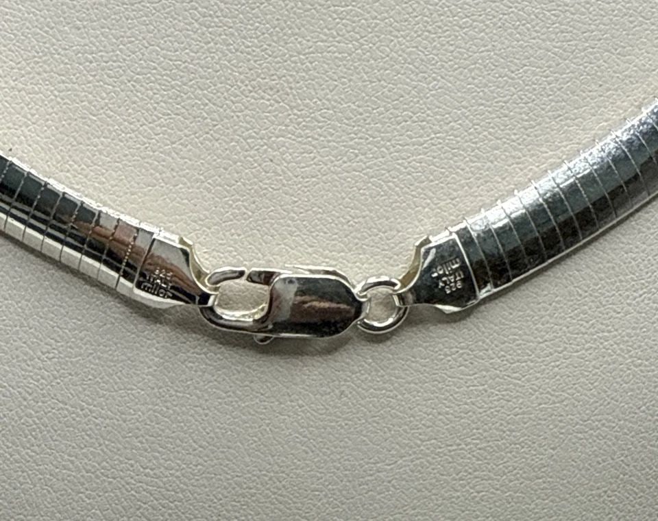 17" STERLING SILVER OMEGA CHAIN NECKLACE 34.1 GRAMS: 17" STERLING SILVER OMEGA CHAIN NECKLACE 34.1 GRAMS This 17" Sterling Silver Omega Chain Necklace is a stunning piece of fine jewelry. Made from 925 sterling silver, this necklace features a classic c