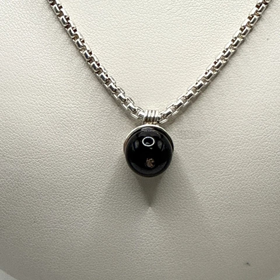 16" STERLING SILVER CHAIN WITH ONYX BALL PENDANT 15 GRAMS: 16" STERLING SILVER CHAIN WITH ONYX BALL PENDANT 15 GRAMS This product is a stunning 16" sterling silver chain with a black onyx ball pendant, weighing 15 grams. The pendant features a lobster closure