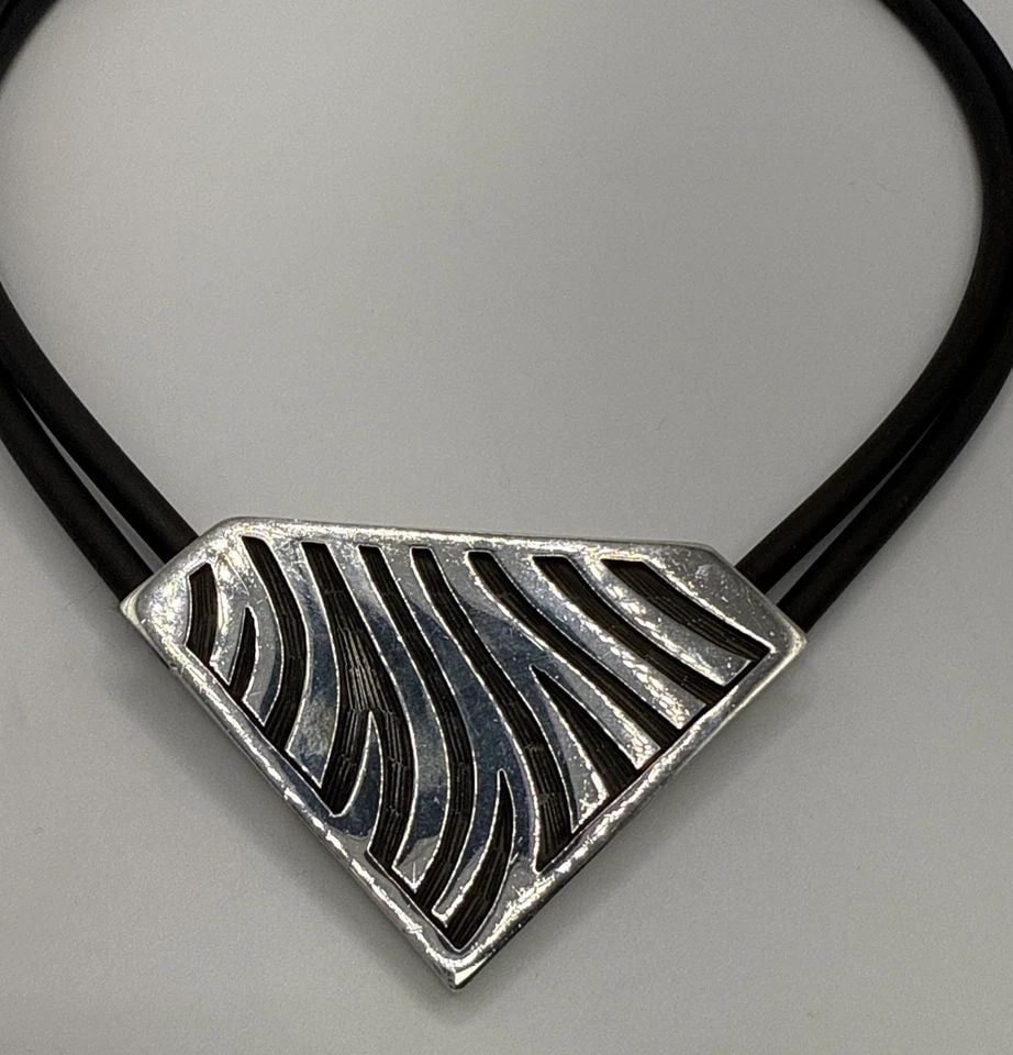 STERLING SILVER PENDANT ON DOUBLE RUBBER CORD CHOKER NECKLACE 15": STERLING SILVER PENDANT ON DOUBLE RUBBER CORD CHOKER NECKLACE 15" This product is a Sterling Silver Pendant on a Double Rubber Cord Choker Necklace, measuring 15 inches in length. The pendant is craft