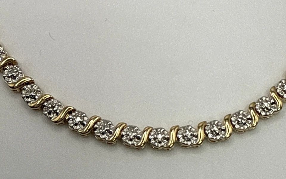 7.5" TWO TONE STERLING SILVER BRACELET 11.2 GRAMS: 7.5" TWO TONE STERLING SILVER BRACELET 11.2 GRAMS This product is a 7.5" two-tone sterling silver bracelet weighing 11.2 grams. It features a chain style design with a colorless main stone set in 925 