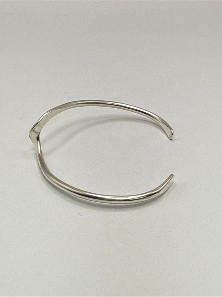 STERLING SILVER WAVE CUFF BRACELET 7.5 GRAMS: STERLING SILVER WAVE CUFF BRACELET 7.5 GRAMS This Sterling Silver Wave Cuff Bracelet is a stylish and elegant piece of fine jewelry. Crafted from 925 sterling silver, the cuff style bracelet has a sle