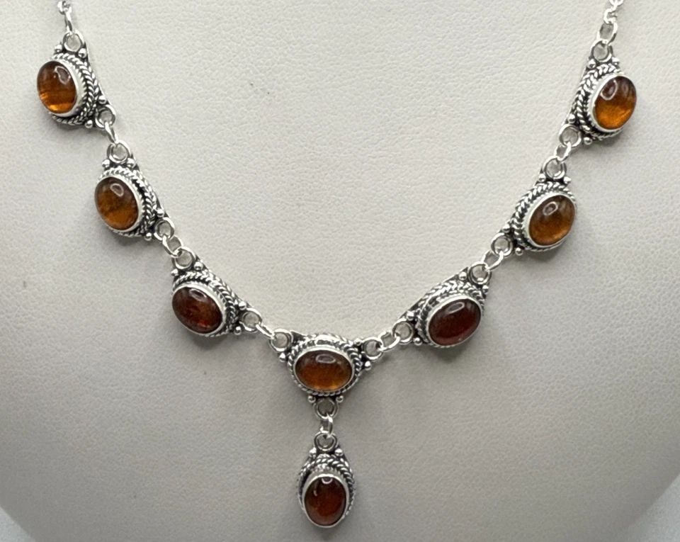 925 STERLING SILVER AND AMBER NECKLACE: 925 STERLING SILVER AND AMBER NECKLACE 925 STERLING SILVER AND AMBER NECKLACE This 925 Sterling Silver and Amber Necklace features a stunning cognac-colored cabochon Amber stone set in a bezel setting