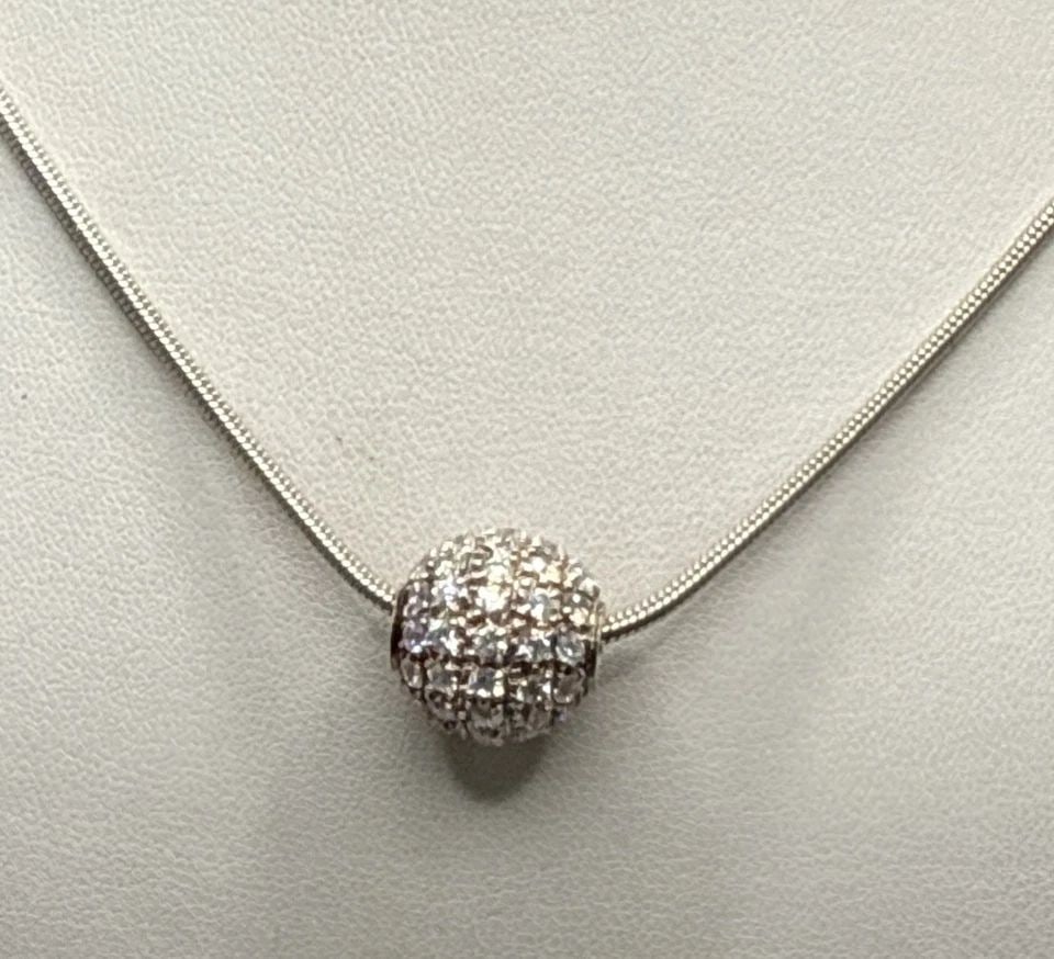 19" STERLING SILVER SNAKE CHAIN WITH COLORLESS STONE BALL CHARM: 19" STERLING SILVER SNAKE CHAIN WITH COLORLESS STONE BALL CHARM 19" STERLING SILVER SNAKE CHAIN WITH COLORLESS STONE BALL CHARM Crafted with precision, this 19-inch sterling silver snake chain is a te