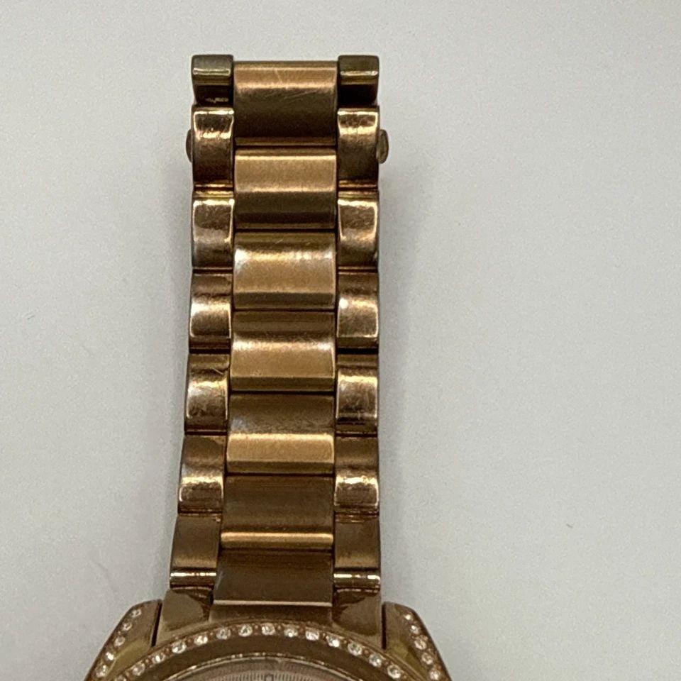 MICHAEL KORS BLAIR GLITZ ROSE GOLD WATCH WITH COLORLESS STONES: MICHAEL KORS BLAIR GLITZ ROSE GOLD WATCH WITH COLORLESS STONES The Michael Kors Blair Glitz Rose Gold Watch with Colorless Stones is a stylish feminine timepiece designed for women. This quartz moveme