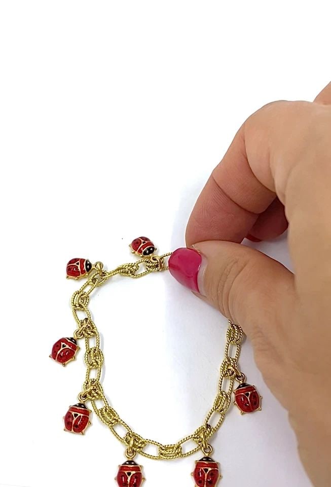 18K GOLD CHAIN 14K GOLD ENAMEL LADYBUG CHARMS BRACELET: 18K GOLD CHAIN 14K GOLD ENAMEL LADYBUG CHARMS BRACELET Product details: MATERIALS: Charms - 14k Gold, Chain - 18k Gold, Enamel WEIGHT: 11.8 Grams MEASUREMENTS: Length - 7", Charm - 1/4" x 5/16" HALLMA