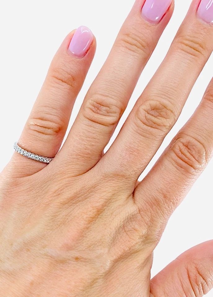 MORELLI PLATINUM PINPOINT DIAMOND ETERNITY RING: MORELLI PLATINUM PINPOINT DIAMOND ETERNITY RING Product details: DESIGNER: Paul Morelli CIRCA: Late 20th Century MATERIALS: Platinum GEMSTONE: Diamond WEIGHT: 2.5 Grams MEASUREMENTS: 1/8" Width RING S