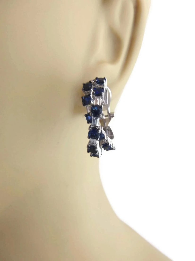 DIAMOND & SAPPHIRE GOLD EARRINGS 18K WHITE DOUBLE CROSSOVER LARGE HOOPS: DIAMOND & SAPPHIRE GOLD EARRINGS 18K WHITE DOUBLE CROSSOVER LARGE HOOPS These Diamond & Sapphire Gold Earrings are crafted with 18k white gold and feature a double crossover design with large hoops. T