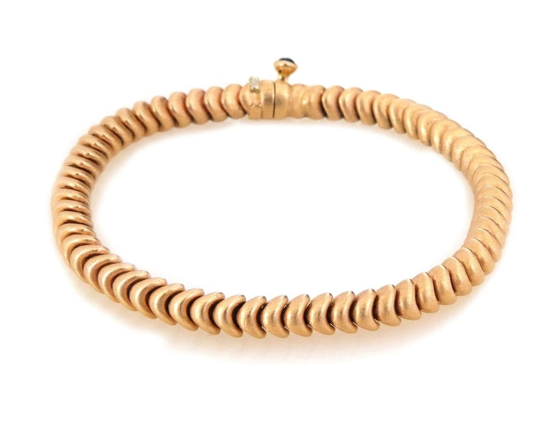 CHANEL PENDANT CAMELLIA 18K YELLOW GOLD WHITE FLOWER: The Chanel Pendant Camellia is a stunning piece made of 18k yellow gold with a white flower design. The pendant is set with a prong style and is signed by Chanel. Featuring a white stone as the main s