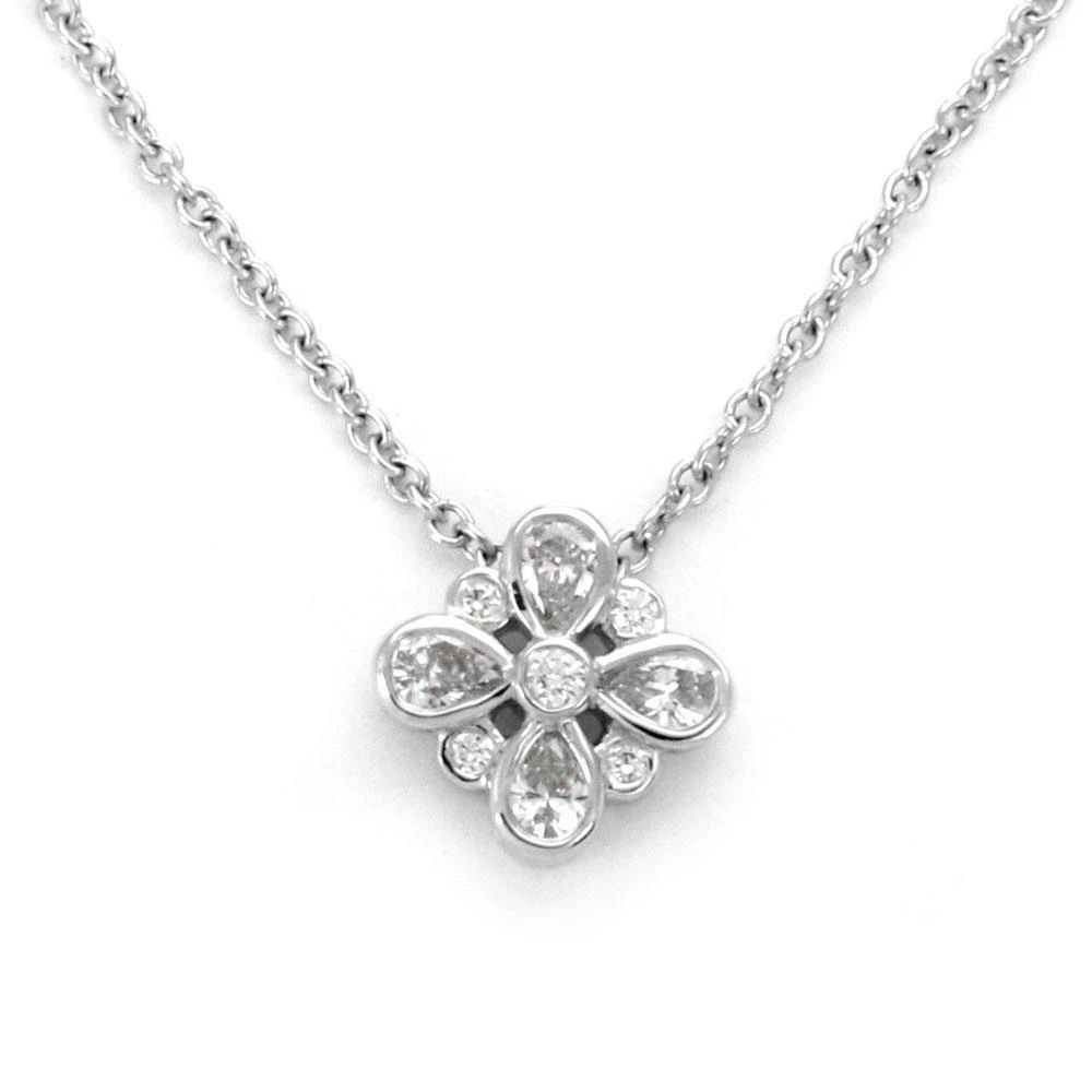 DIAMOND GOLD FLOWER EARRINGS 18K YELLOW DOGWOOD POST CLIP STYLE: This lovely pair of earrings are crafted from 18k yellow gold earrings featuring a beautiful dogwood flower design with a cluster of natural white diamonds set in the center of the flower. The petals 