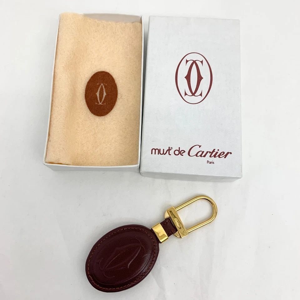 AUTHENTIC CARTIER DECOR LOGO LEATHER CLASSIC KEYCHAIN GOLD GP SIGNATURE CHARM: AUTHENTIC CARTIER DECOR LOGO LEATHER CLASSIC KEYCHAIN GOLD GP SIGNATURE CHARM AUTHENTIC CARTIER DECOR LOGO LEATHER CLASSIC KEYCHAIN GOLD GP SIGNATURE CHARM Cartier Signature, Classic, Logo Keychain Ch