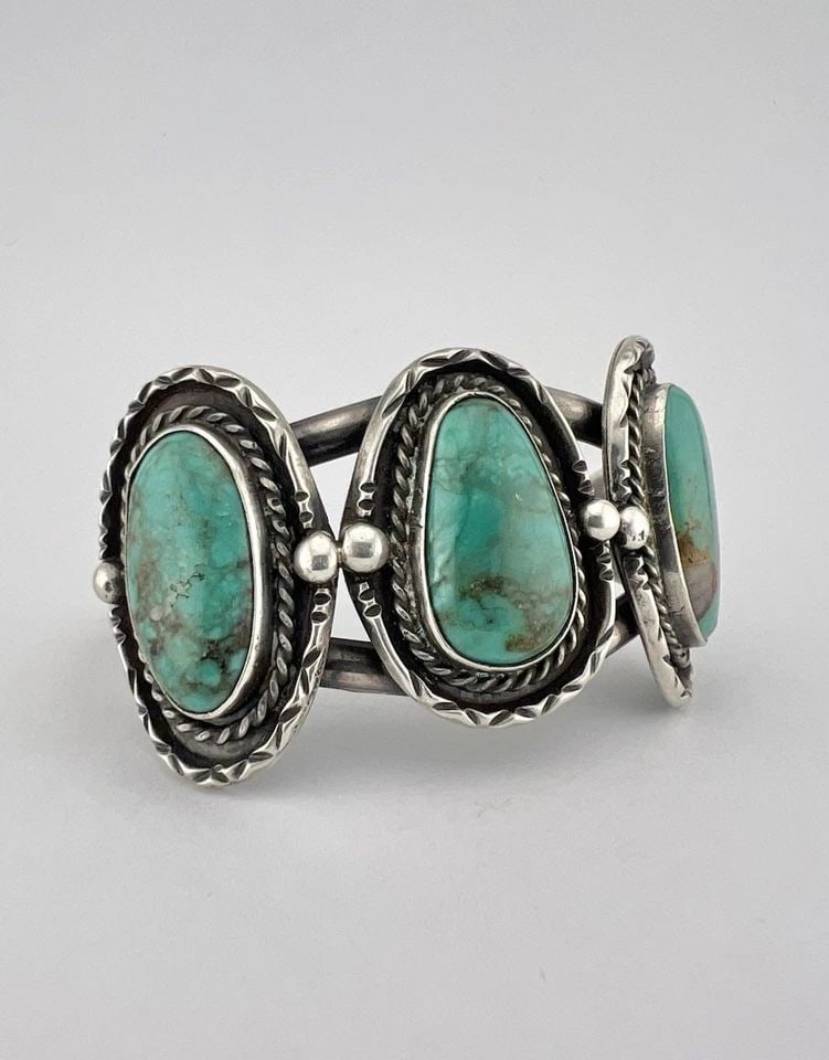 VINTAGE NAVAJO STERLING SILVER PILOT MOUNTAIN TURQUOISE STAMPED CUFF BRACELET: Vintage Navajo Sterling Silver Pilot Mountain Turquoise Stamped Cuff Bracelet Cuff is Just Under 4 3/4" tip to Tip and has a 1 1/8" Wide Adjustable Gap Cuff Is 1 1/4" Wide In the Center Weight is 43.2