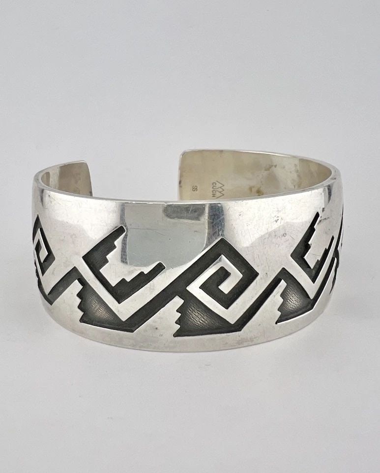 VINTAGE HOPI CASEY CUCH STERLING SILVER TRIBAL WIDE CUFF BRACELET 67.6G: VINTAGE HOPI CASEY CUCH STERLING SILVER TRIBAL WIDE CUFF BRACELET 67.6G Vintage Hopi Casey Cuch Sterling Silver Tribal Wide Cuff Bracelet 67.6g Cuff is 6 1/8" tip to Tip and has a 1" Wide Adjustable G
