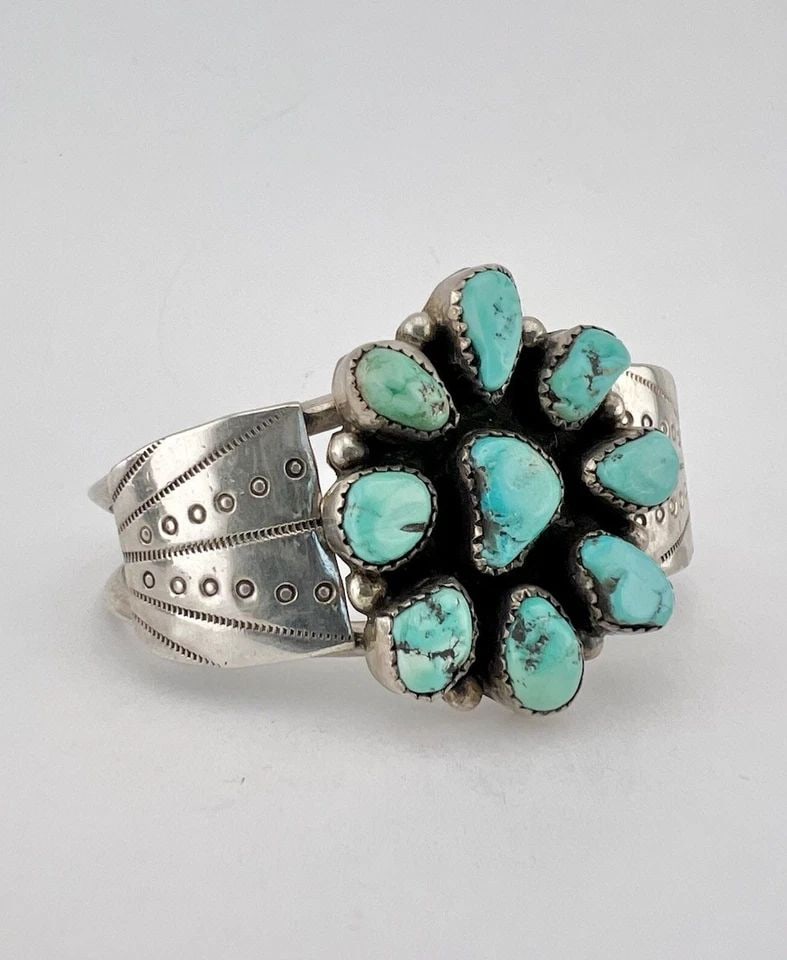 VTG NAVAJO STERLING SILVER NATURAL KINGMAN TURQUOISE CLUSTER CUFF BRACELET: Vtg Navajo Sterling Silver NATURAL Kingman Turquoise Cluster Cuff Bracelet Cuff is 5" tip to Tip and has a Just Under 1 1/4" Wide Adjustable Gap Cuff Is 1 1/2" Wide In the Center Weight is 34.0 Grams 