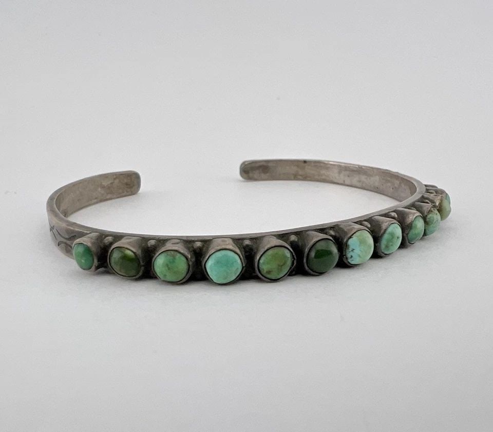 OLD 1940'S ZUNI STERLING SILVER SNAKE EYE TURQUOISE 1 ROW STAMPED CUFF BRACELET: OLD 1940's Zuni Sterling Silver Snake Eye Turquoise 1 Row Stamped Cuff Bracelet Cuff is Just Under 5 3/4" tip to Tip and has a 7/8" Wide Adjustable Gap Cuff Is Just Under 1/4" Wide In The Center Weigh