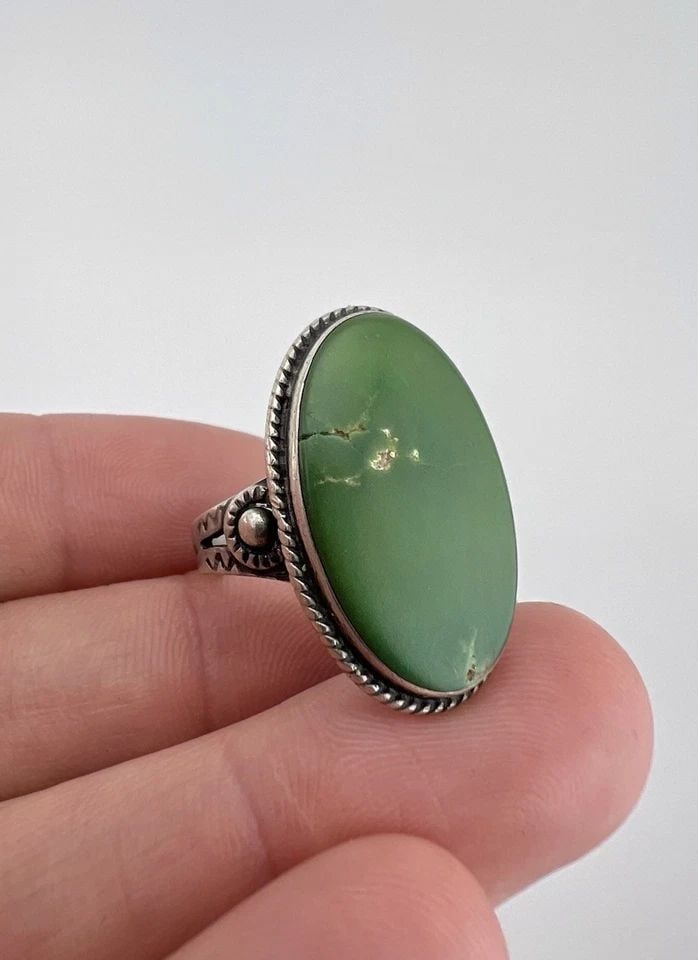 OLD FRED HARVEY ERA NAVAJO STERLING SILVER CERRILLOS TURQUOISE STAMPED OVAL RING: Old Fred Harvey Era Navajo Sterling Silver Cerrillos Turquoise Stamped Oval Ring Ring Size: 7.5 - Can Be Re Sized Weight is 7.5 Grams on my scale Metal: Sterling Silver Ring is 1 1/8" Tall In the Cent