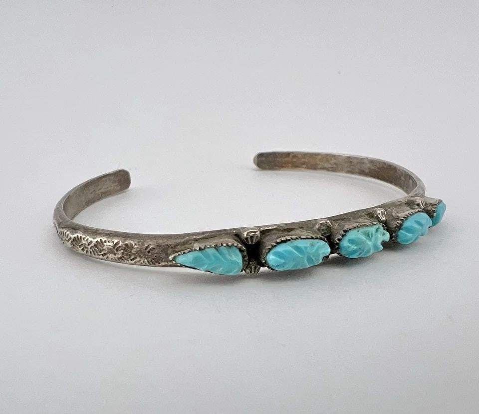 VINTAGE ZUNI CARVED NATURAL TURQUOISE STERLING SILVER STAMPED ROW CUFF BRACELET: Vintage Zuni Carved Natural Turquoise Sterling Silver Stamped Row Cuff Bracelet Cuff is 5 1/2" tip to Tip and has a Just Under 1 1/4" Wide - Adjustable Gap Cuff Is 1/4" Wide In The Center Weight is 11