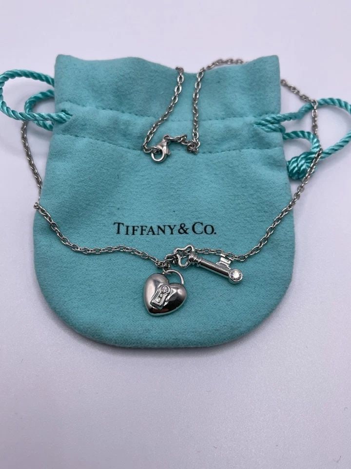 TIFFANY & CO. PLATINUM HEART LOCK AND KEY DIAMOND PENDANT NECKLACE - 16" LONG: Tiffany & Co. Platinum 950 Heart Lock and Key Diamond Pendant Necklace Length - 16" Long Total Weight - 17.2 Grams Professionally Polished & Looks Brand New Pouch Included