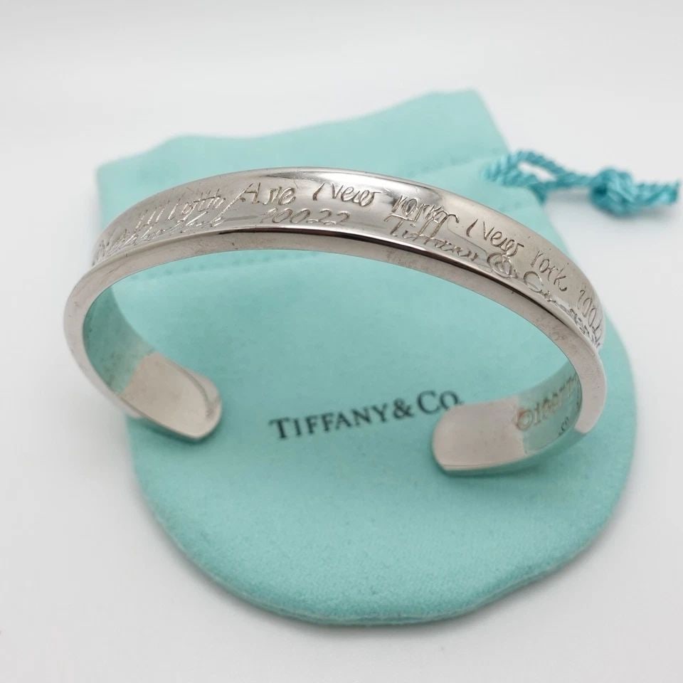 1997 TIFFANY & CO. NOTES STERLING SILVER FIFTH AVE CONCAVE CUFF BRACELET SZ 6.75: Tiffany & Co. Notes Sterling Silver Fifth Ave Concave Cuff Bracelet Size - 6.75" Max Wrist Size w/o Gap - 5.5" Width - 11mm Diameter - 2.4" Total Weight - 34.6 Grams