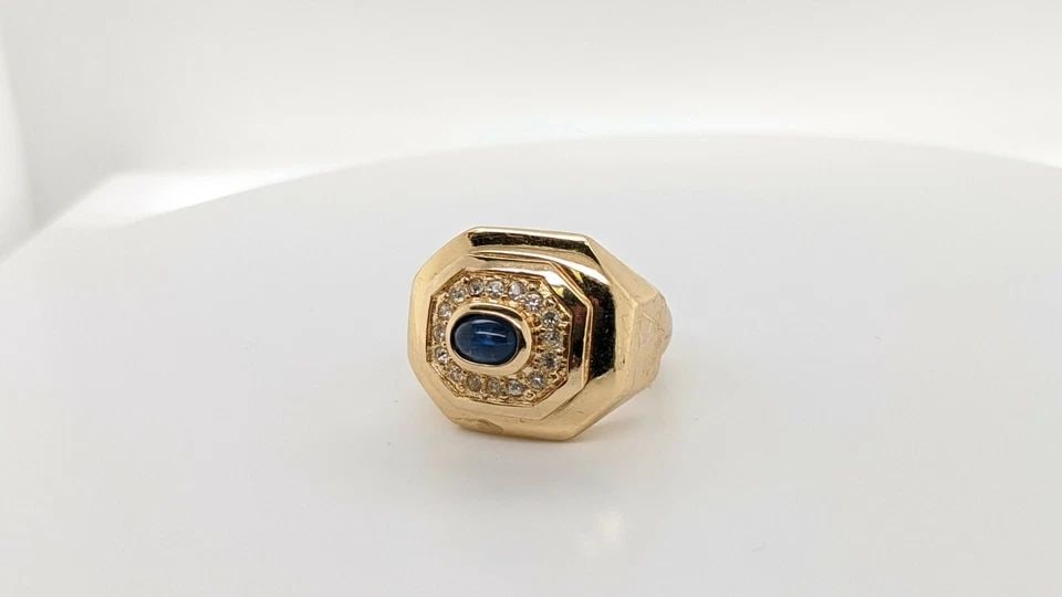 CHRISTIAN DIOR YELLOW GOLD PLATED RING WITH BLUE CABOCHON - ADJUSTABLE RING SIZE: CHRISTIAN DIOR YELLOW GOLD PLATED RING WITH BLUE CABOCHON - ADJUSTABLE RING SIZE Christian Dior Gold Plated Ring With Blue Cabochon Glass Adjustable Ring Size Current Size - 7 Total Weight - 15.5 Gram