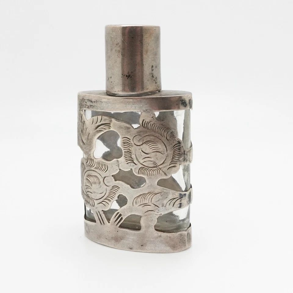 LHM MEXICO STERLING SILVER OVERLAY GLASS PERFUME BOTTLE - 2": LHM MEXICO STERLING SILVER OVERLAY GLASS PERFUME BOTTLE - 2" LHM Mexico Sterling Silver Overlay Glass Perfume Bottle Height - 2" Width - 1.2" Total Weight - 20 Grams