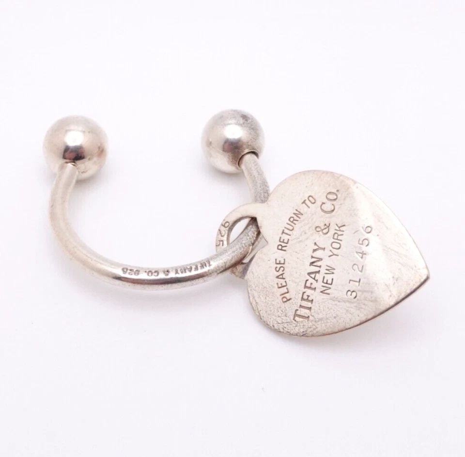 TIFFANY & CO. RETURN TO STERLING SILVER KEY CHAIN HEART TAG CHARM: Tiffany & Co. Sterling Silver Return To Tiffany Heart Tag Screwball Key Tag Height - 1" in. approx. Tag Width - 3/4" in. approx. Est. Retail 250 Pouch NOT Included