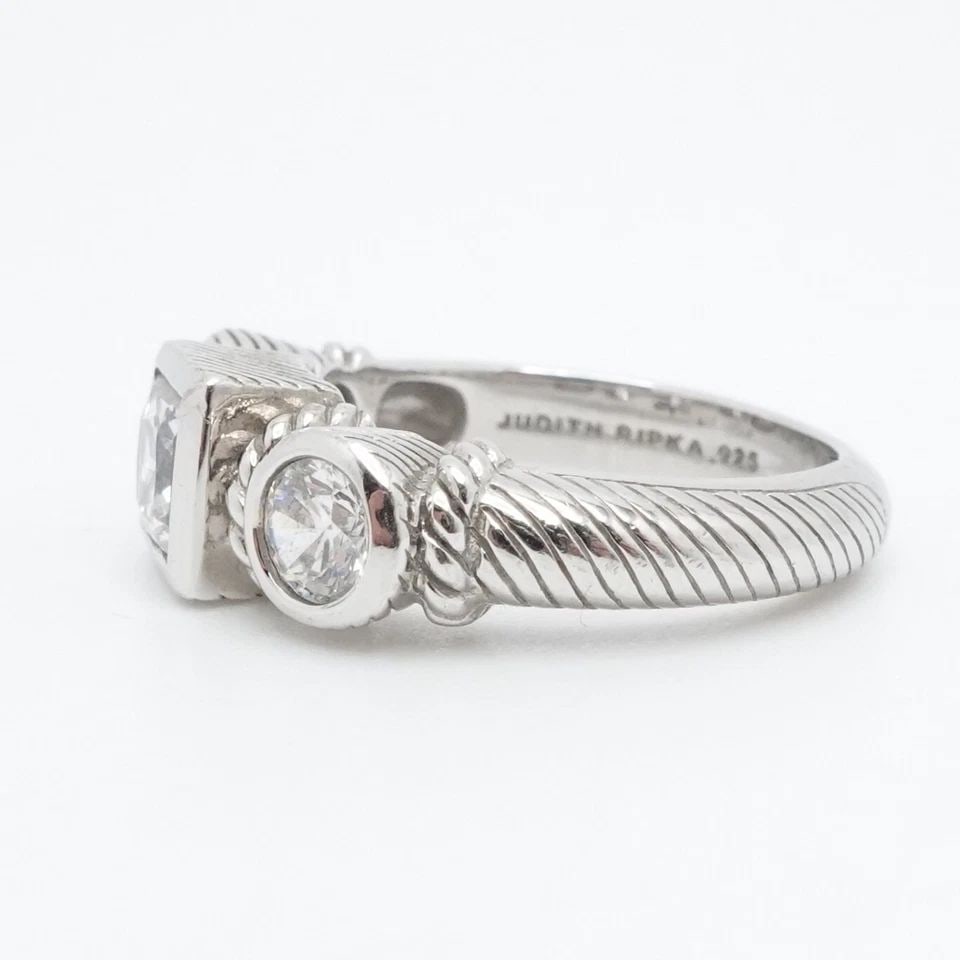 JUDITH RIPKA STERLING SILVER 3 CLEAR CUBIC ZIRCONIA CABLE RING SIZE 6.25: JUDITH RIPKA STERLING SILVER 3 CLEAR CUBIC ZIRCONIA CABLE RING SIZE 6.25 Judith Ripka Sterling Silver Square & Circle Bezel 3 Clear Cubic Zirconia Cable Ring Size - 6.25 Band Width - 3mm Height - 6mm 