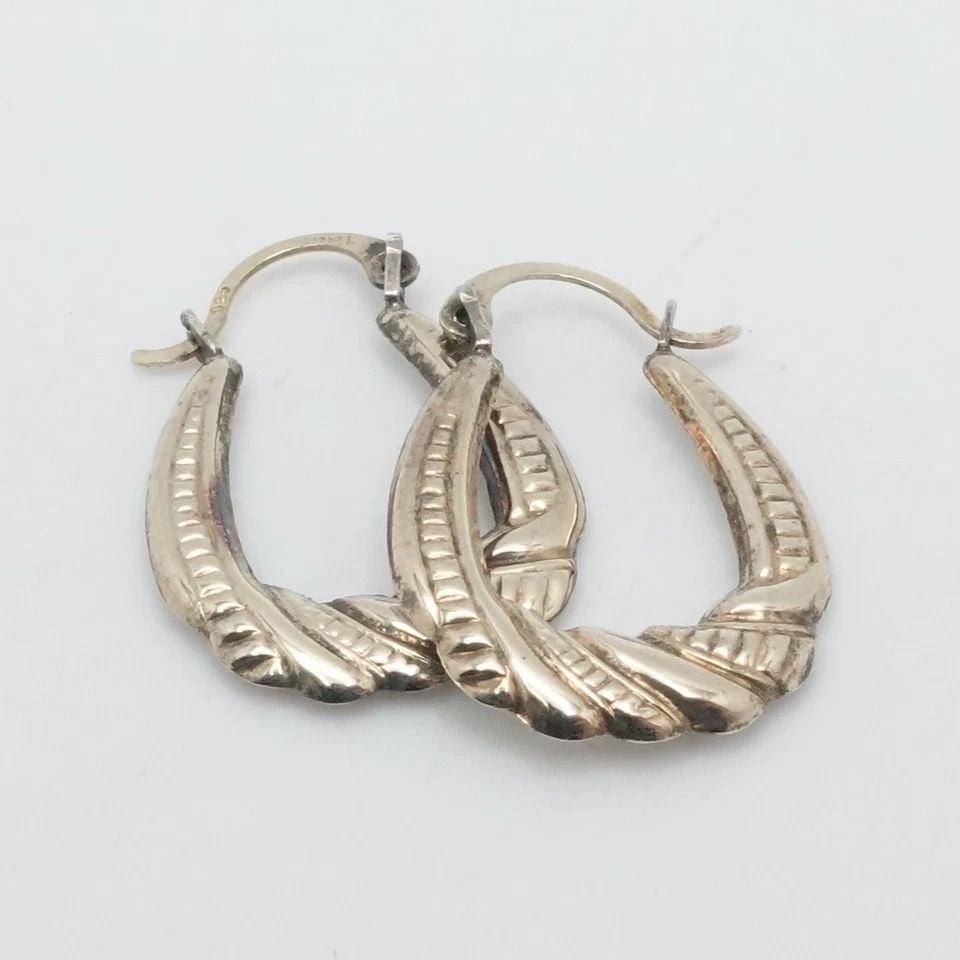 SLC STERLING SILVER 14K YELLOW GOLD TWIST HOOP EARRINGS 3/4": SLC STERLING SILVER 14K YELLOW GOLD TWIST HOOP EARRINGS 3/4" SLC Sterling Silver 14K Gold Two Tone Twist Hoop Earrings 3/4" Height - 20mm Width - 15mm Depth - 1.5mm Thick Total Weight - 1 Grams Hallma