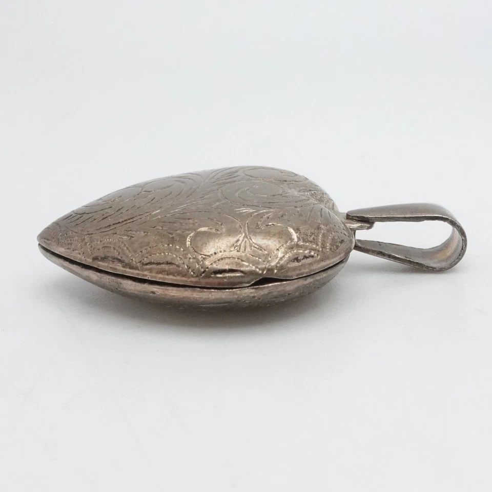 STERLING SILVER FILIGREE HEART LOCKET PENDANT 1.75": STERLING SILVER FILIGREE HEART LOCKET PENDANT 1.75" Sterling Silver Filigree Heart Locket Pendant Total Height - 1.75" Bail Size - 4.5 x 9mm Inner Size - 22mm x 24mm Total Weight - 10 Grams
