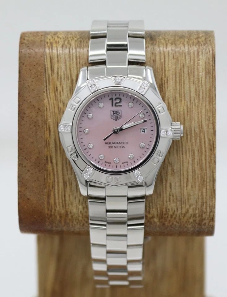 TAG HEUER AQUARACER 27MM PINK MOP DIAMOND DIAL & BEZEL QUARTZ WATCH WAF141H: TAG HEUER AQUARACER 27MM PINK MOP DIAMOND DIAL & BEZEL QUARTZ WATCH WAF141H Description TAG Heuer Aquaracer 27mm Pink MOP Diamond Dial & Bezel Quartz Watch WAF141H The watch has been used previously. 