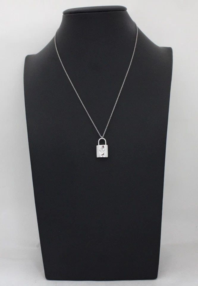 TIFFANY & CO. DIAMOND 18K WHITE GOLD PADLOCK PENDANT & CHAIN NECKLACE 16": TIFFANY & CO. DIAMOND 18K WHITE GOLD PADLOCK PENDANT & CHAIN NECKLACE 16" Description Tiffany & Co. Diamond 18k White Gold Padlock Pendant & Chain Necklace 16" Necklace/pendant is in good condition. M