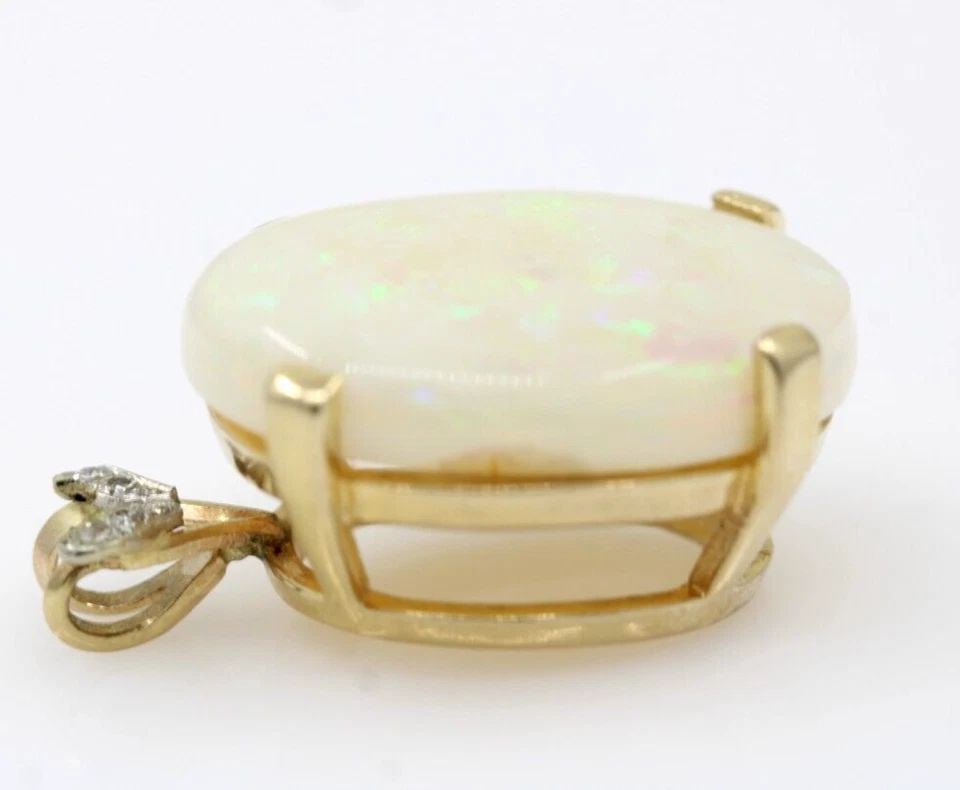 14K YELLOW GOLD OPAL & DIAMOND PENDANT 6.4 GRAMS: 14K YELLOW GOLD OPAL & DIAMOND PENDANT 6.4 GRAMS 14K YELLOW GOLD OPAL & DIAMOND PENDANT 6.4 GRAMS Description 14K Yellow Gold Opal & Diamond Pendant Item is in good condition. May show signs of wear. 