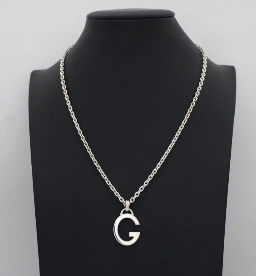 GUCCI STERLING SILVER G LOGO PENDANT NECKLACE 17" W/ BOX/POUCH 19.2 GRAMS: GUCCI STERLING SILVER G LOGO PENDANT NECKLACE 17" W/ BOX/POUCH 19.2 GRAMS Description Gucci Sterling Silver G Logo Pendant Necklace 17" w/ Box/Pouch Pendant & chain is in good condition. May show sign