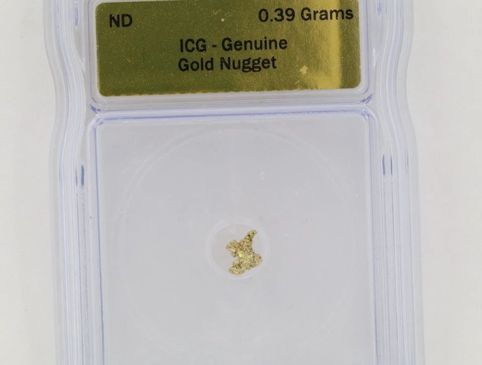ICG GRADED CERTIFIED GENUINE NATURAL GOLD NUGGET 0.39 GRAMS SLABBED: ICG GRADED CERTIFIED GENUINE NATURAL GOLD NUGGET 0.39 GRAMS SLABBED Description ICG Graded Certified Genuine Natural Gold Nugget 0.39 Grams Slabbed Gold nugget is in uncirculated graded condition. The