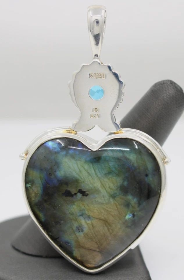 SAJEN STERLING SILVER LABRADORITE HEART & BLUE TOPAZ PENDANT: SAJEN STERLING SILVER LABRADORITE HEART & BLUE TOPAZ PENDANT Description Sajen Sterling Silver Labradorite Heart & Blue Topaz Pendant Pendant is in good condition. May show signs of wear and/or tear. 