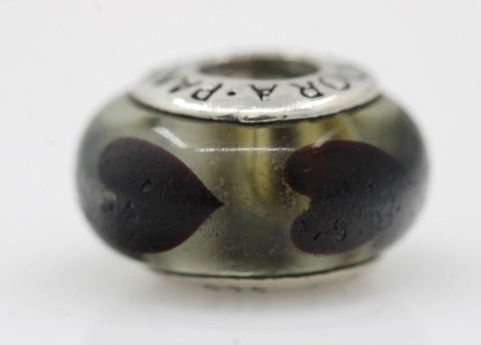 AUTHENTIC PANDORA STERLING CLEAR LOVE WITH BLACK HEARTS MURANO CHARM #790665FZ: AUTHENTIC PANDORA STERLING CLEAR LOVE WITH BLACK HEARTS MURANO CHARM #790665FZ Description Authentic Pandora Sterling Clear Love With Black Hearts Murano Charm #790665FZ Pandora charm in good conditio