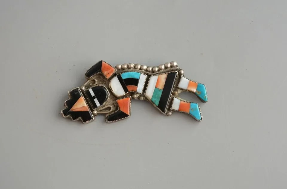 OLD PAWN ZUNI INDIAN STERLING SILVER INLAYED RAINBOW MAN PIN - 3": OLD PAWN ZUNI INDIAN STERLING SILVER INLAYED RAINBOW MAN PIN - 3" Item Description: This old pawn Zuni rainbow man pin was obviously made by one of the Zuni masters. The inlay has been beautifully don