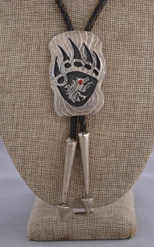BRIAN KAGENVEMA - VINTAGE HOPI STERLING SILVER BEAR PAW - TUFA CAST: BRIAN KAGENVEMA - VINTAGE HOPI STERLING SILVER BEAR PAW - TUFA CAST Item Description: This unique sterling silver bolo tie has been beautifully crafted by Hopi silversmith Brian Kagenvema. It shows a 