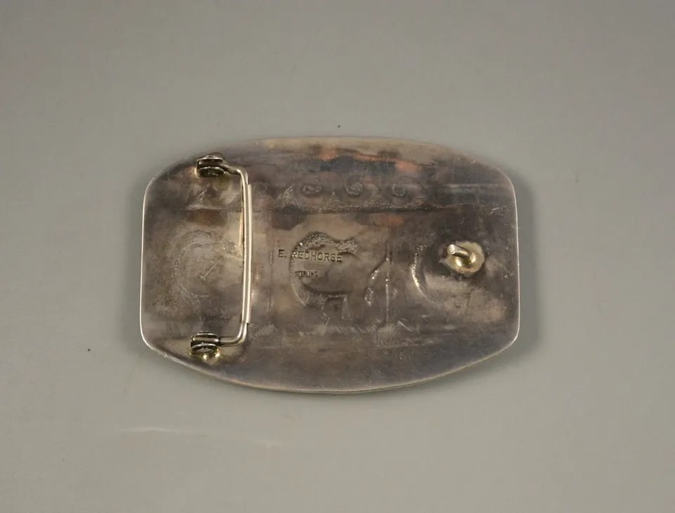 LG VINTAGE NAVAJO STERLING SILVER BUCKLE -BY ERVIN REDHORSE - 3.5" X 2.5" 60GM: LG VINTAGE NAVAJO STERLING SILVER BUCKLE -BY ERVIN REDHORSE - 3.5" X 2.5" 60GM Item Description: This vintage sterling silver buckle shows a scene with Kokopelli playing flutes. Kokopelli arrive in th