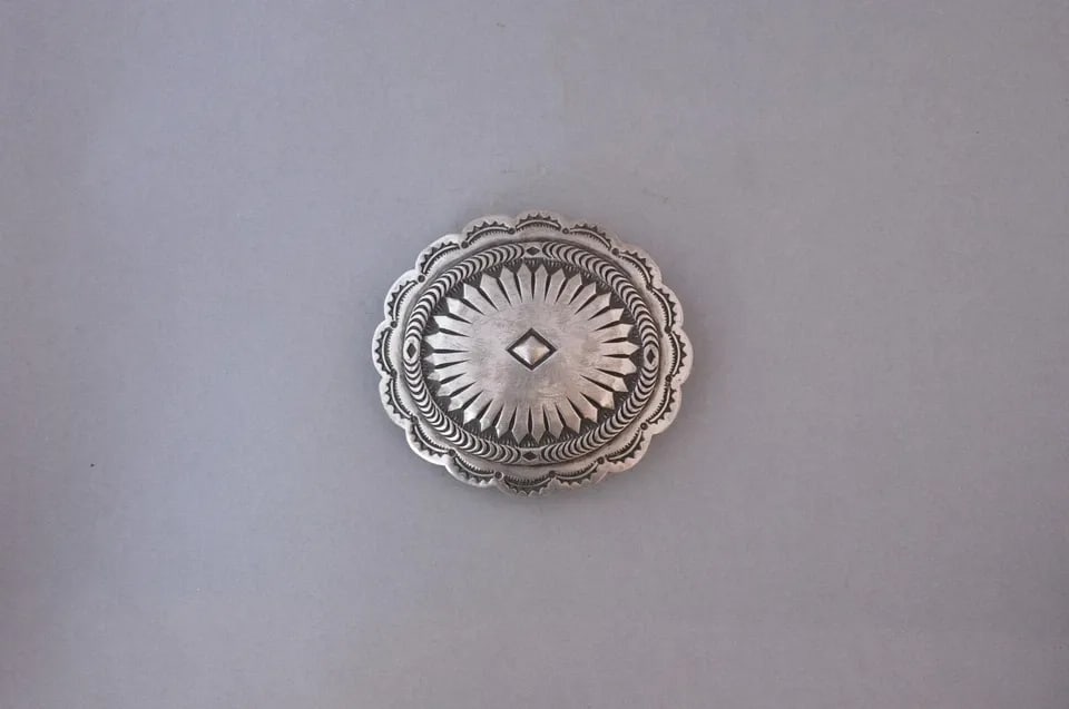 OLD PAWN NAVAJO STERLING SILVER HANDSTAMPED OVAL CONCHO BELT BUCKLE - 2 5/8": OLD PAWN NAVAJO STERLING SILVER HANDSTAMPED OVAL CONCHO BELT BUCKLE - 2 5/8" This vintage Navajo concho belt buckle has been beautifully crafted. It has a sunray design with a scalloped handstamped bo