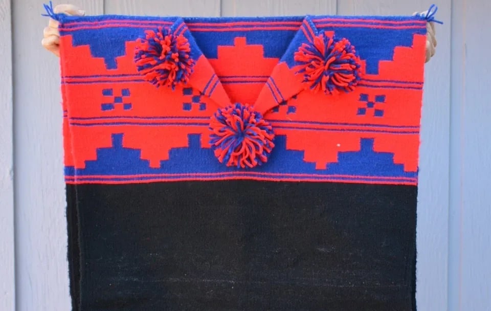 TRADITIONAL HANDWOVEN NAVAJO WOOL RUG DRESS - BIIL - BLUE RED BLACK - TASSLES: TRADITIONAL HANDWOVEN NAVAJO WOOL RUG DRESS - BIIL - BLUE RED BLACK - TASSLES This is a traditional handwoven Navajo wool rug dress or Biil. It is composed of two panels that are connected at the shou