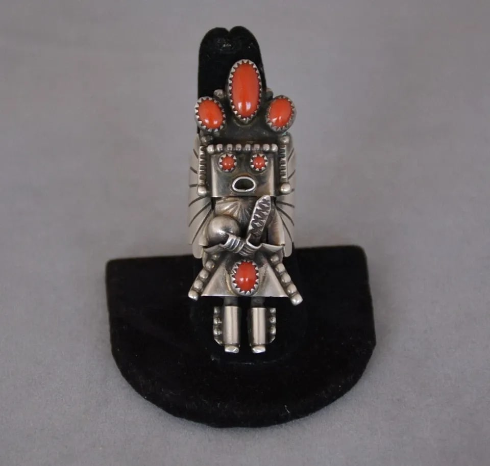 DORIS SMALLCANYON - STERLING SILVER KACHINA YEI RING - CORAL STONES - SIZE 7: DORIS SMALLCANYON - STERLING SILVER KACHINA YEI RING - CORAL STONES - SIZE 7 This sterling silver ring has been beautifully crafted by Navajo silversmith Doris Smallcanyon. It is 2 1/4" tall and weigh