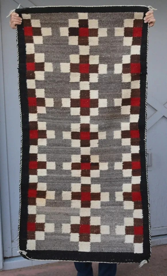 VINTAGE NAVAJO GANADO RUG - CHECKER CROSS HANDSPUN - RED GRAY BROWN 57 X 29: VINTAGE NAVAJO GANADO RUG - CHECKER CROSS HANDSPUN - RED GRAY BROWN 57 X 29 This older Ganado Navajo rug has a checkboard cross pattern woven in the classic Ganado colors in handspun wools. It measure