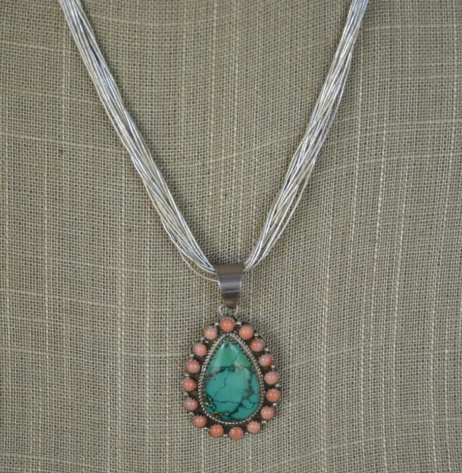 NAVAJO NECKLACE ANGEL SKIN CORAL TEARDROP TURQUOISE PENDANT LIQUID SILVER 18": NAVAJO NECKLACE ANGEL SKIN CORAL TEARDROP TURQUOISE PENDANT LIQUID SILVER 18" This beautifully crafted Navajo necklace has a teardrop turquoise stone surrounded with angel skin coral stones. The penda