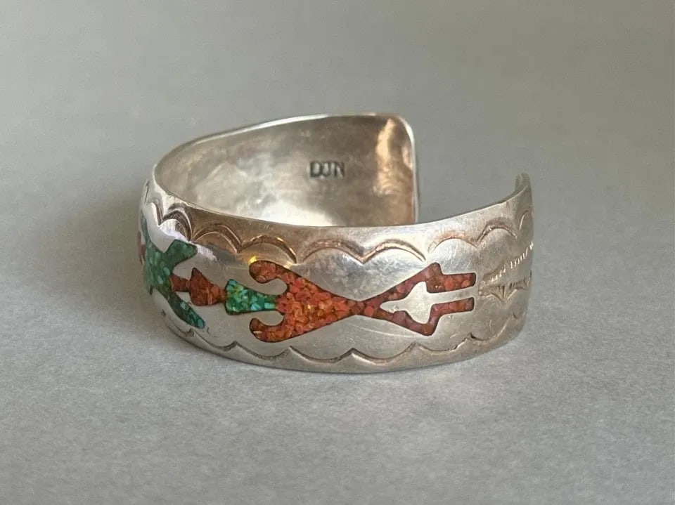 VINTAGE NAVAJO STERLING SILVER WITH INLAID TURQUOISE AND CORAL BRACELET.: VINTAGE NAVAJO STERLING SILVER WITH INLAID TURQUOISE AND CORAL BRACELET. Vintage Navajo Sterling Silver with Inlaid Turquoise and Coral Bracelet. Signed DJN. 3/4" Wide ..5 1/4" Inside 1 1/8" Opening .