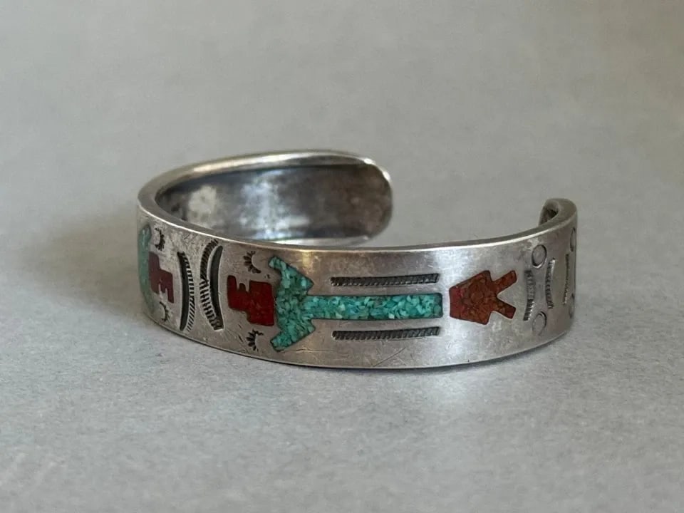 OLD PAWN NAVAJO STERLING SILVER WITH INLAID TURQUOISE AND CORAL KACHINA BRACELET: OLD PAWN NAVAJO STERLING SILVER WITH INLAID TURQUOISE AND CORAL KACHINA BRACELET Old Pawn Navajo Sterling Silver with Inlaid Turquoise and Coral Kachina Bracelet 1/2" wide ... 4 3/4" Around Inside .. 
