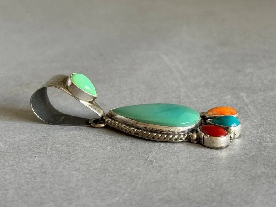 VINTAGE NAVAJO DANIEL MIKE STERLING SILVER TURQUOISE CORAL SPINY OYSTER PENDANT: VINTAGE NAVAJO DANIEL MIKE STERLING SILVER TURQUOISE CORAL SPINY OYSTER PENDANT Vintage Navajo Daniel Mike Sterling Silver with Turquoise, Coral and Spiny Oyster Pendant .. 2 3/8" Tall Throughout the 