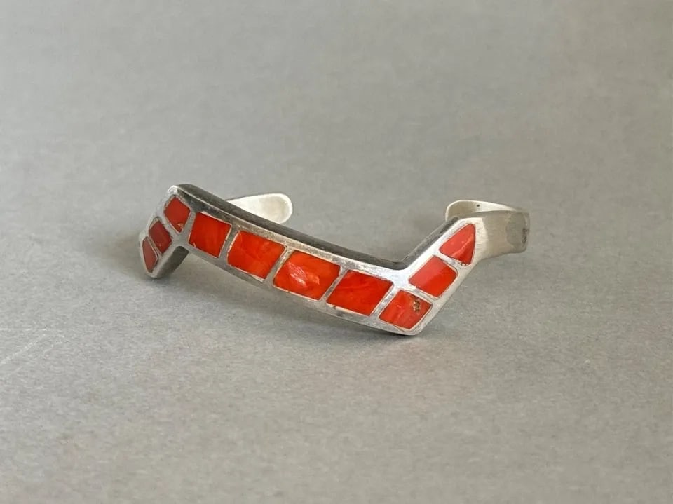 VINTAGE ZUNI STERLING SILVER WITH INLAID CORAL BRACELET: VINTAGE ZUNI STERLING SILVER WITH INLAID CORAL BRACELET Vintage Zuni Sterling Silver with Inlaid Coral Bracelet 3/8" Wide x 3/16 Thick ..weighs 34 Grams Has a silver repair on the side of bracelet is 