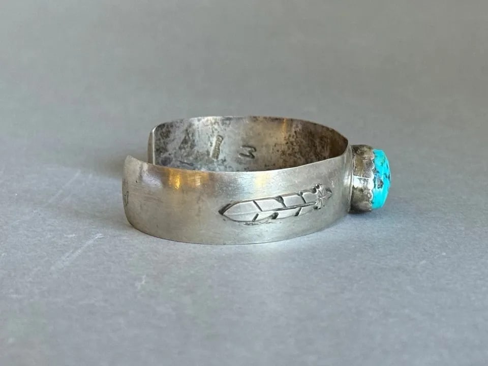 VINTAGE NAVAJO STERLING SILVER AND TURQUOISE BRACELET WITH FEATHERS SIGNED M: VINTAGE NAVAJO STERLING SILVER AND TURQUOISE BRACELET WITH FEATHERS SIGNED M Vintage Navajo Sterling Silver and Turquoise Bracelet with Feathers. 1/2" Wide .. 5" Inside with a 1 1/4" Opening ..