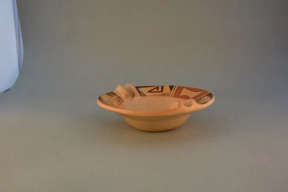 DELORES NAMOKI - VINTAGE HOPI POT DISH - POLYCHROME - 6" ACROSS - 2" HIGH: DELORES NAMOKI - VINTAGE HOPI POT DISH - POLYCHROME - 6" ACROSS - 2" HIGH This vintage Hopi dish has a nicely painted design of traditional Hopi symbols around the lip at the top. It measures 6" acros