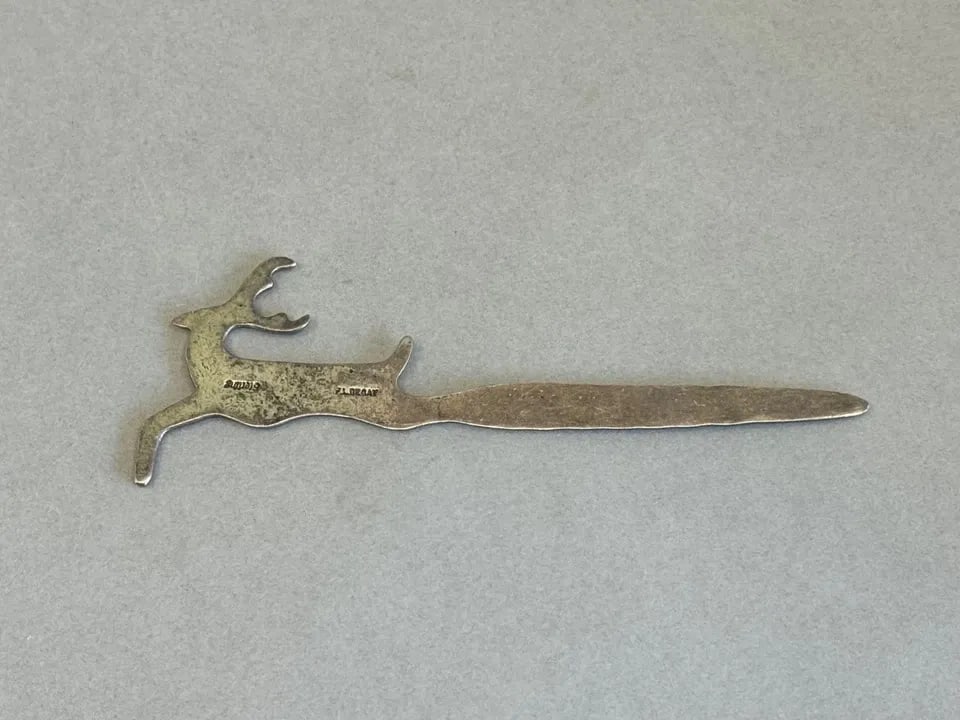 VINTAGE NAVAJO PICTORAL ELK LETTER OPENER. SIGNED FL BEGAY 4 1/2": VINTAGE NAVAJO PICTORAL ELK LETTER OPENER. SIGNED FL BEGAY 4 1/2" Vintage Navajo Pictoral Elk Letter Opener. Signed FL Begay 4 1/2 " 15 Grams